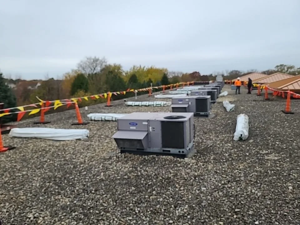 Aging ballasted EPDM roof on Lockport retail center before recover