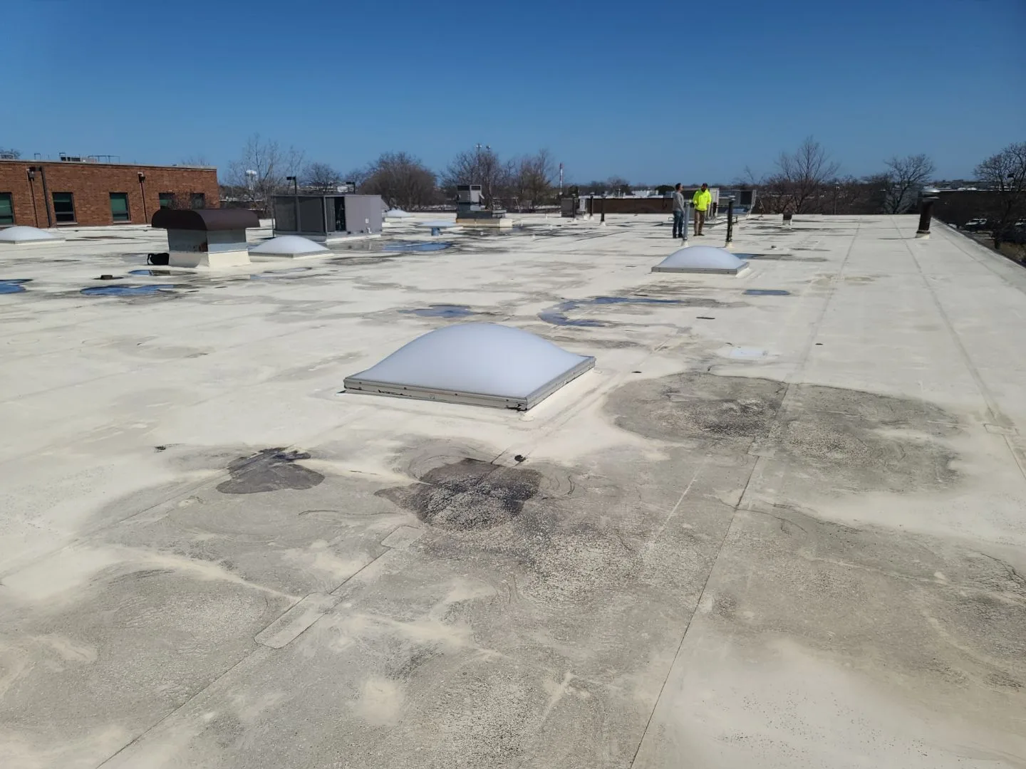 Deteriorating TPO roof on Northbrook industrial facility before recover