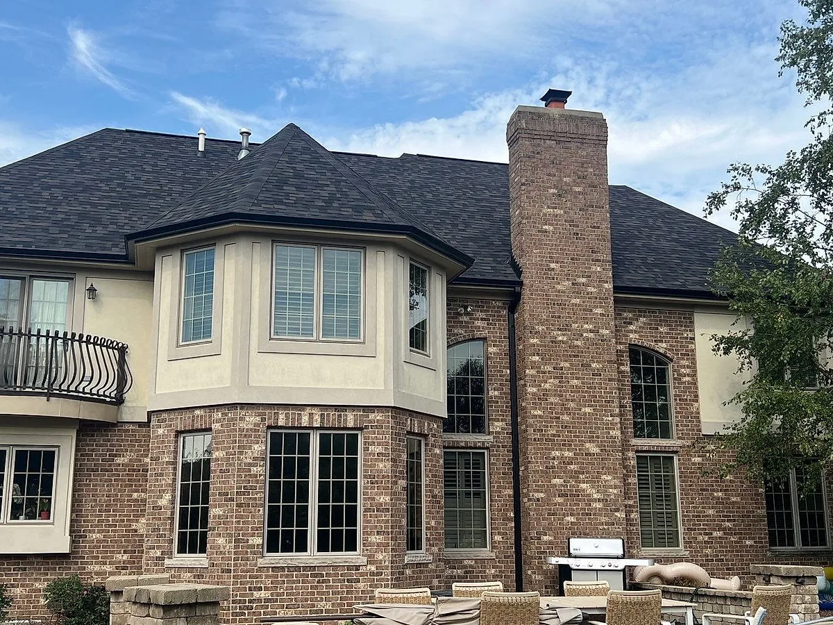 Motto Homer Glen home rear elevation with new roof, seamless gutters, and downspouts