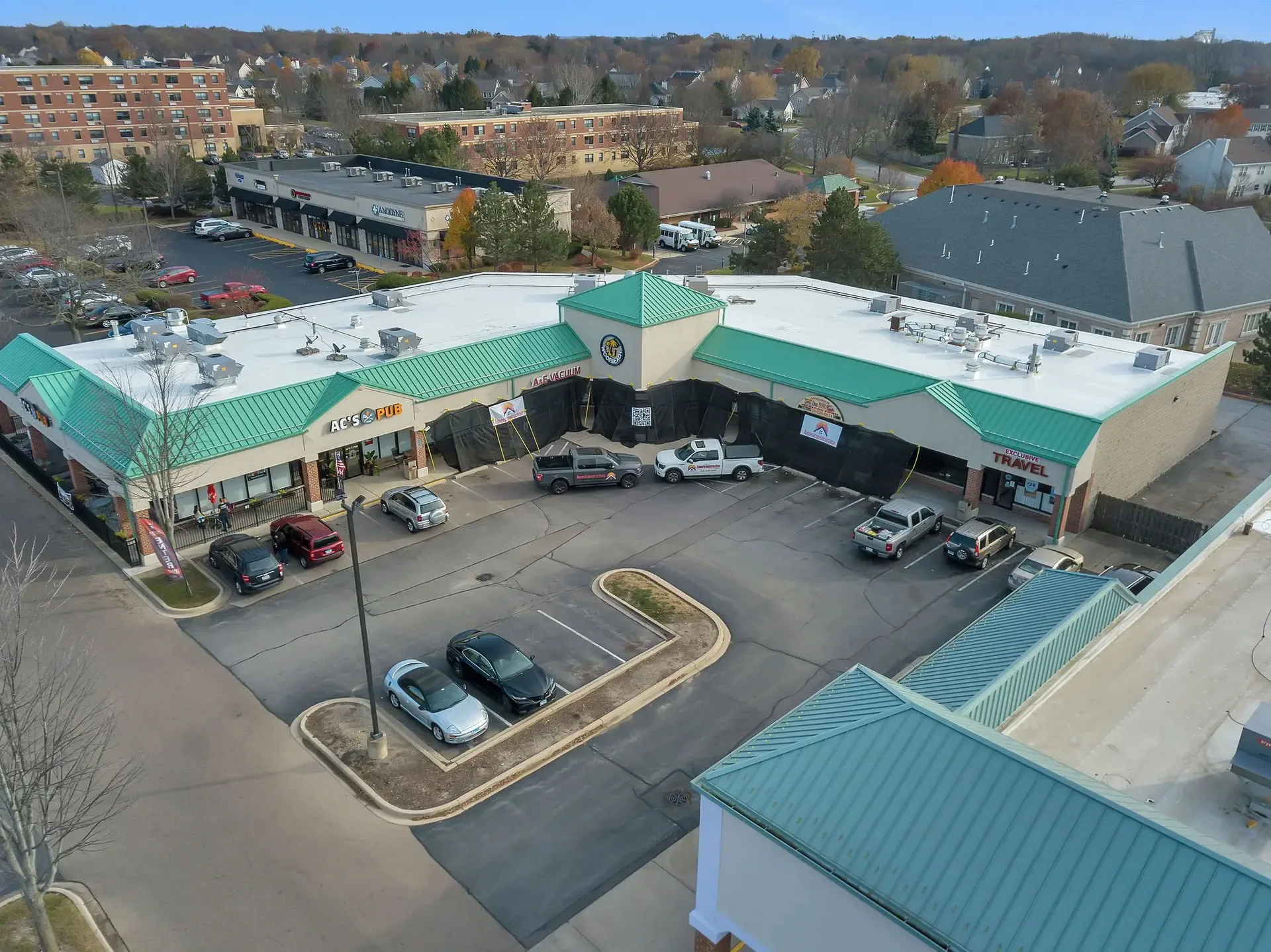 Aerial of a completed commercial retail center roof recover by Americanstruction
