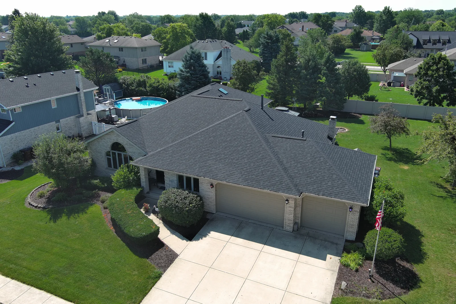 Drone view of a completed architectural shingle roof by Americanstruction