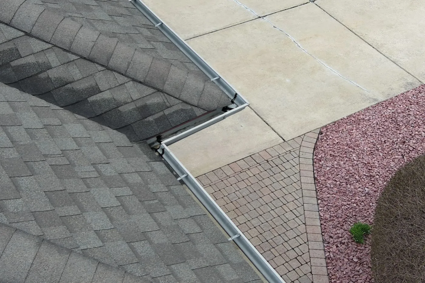 Newly installed seamless aluminum gutters on residential roofline