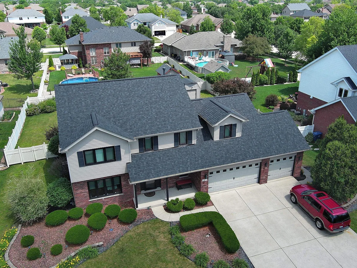 Drone aerial view of completed residential roof replacement on a Mokena home documented by Americanstruction
