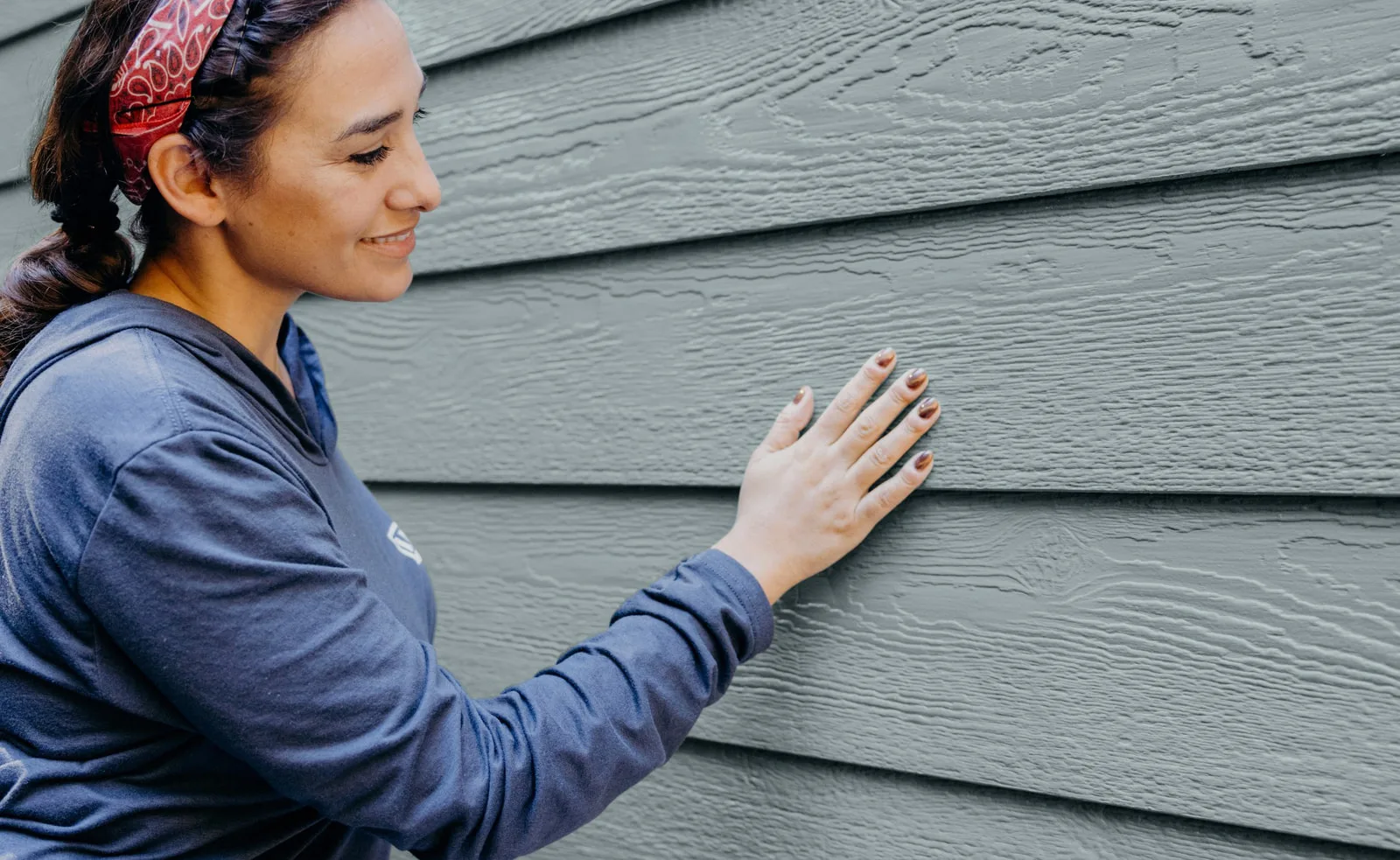 Close-up of LP SmartSide engineered wood lap siding showing the cedar-grain texture and shadow lines