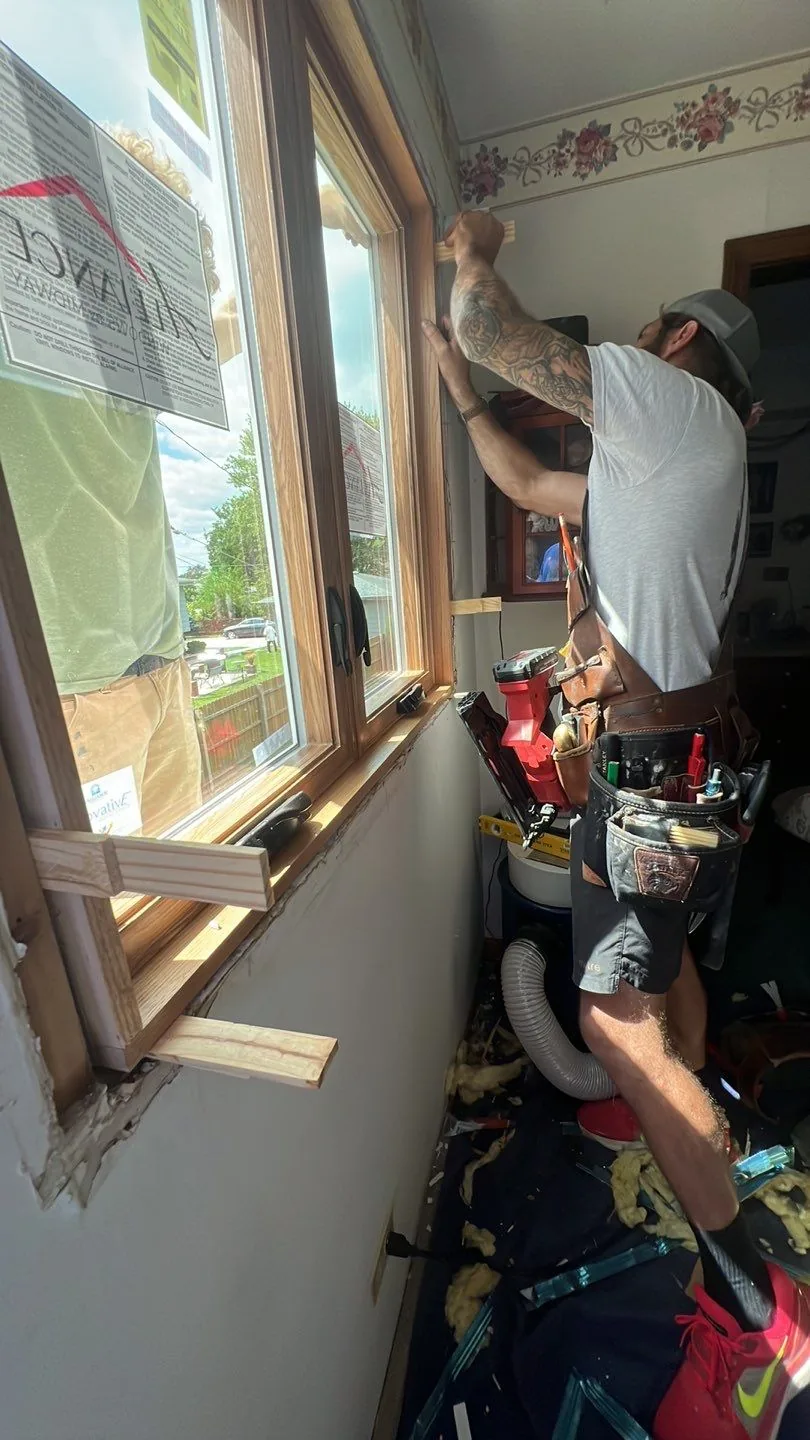 Americanstruction installer fitting and trimming a new window